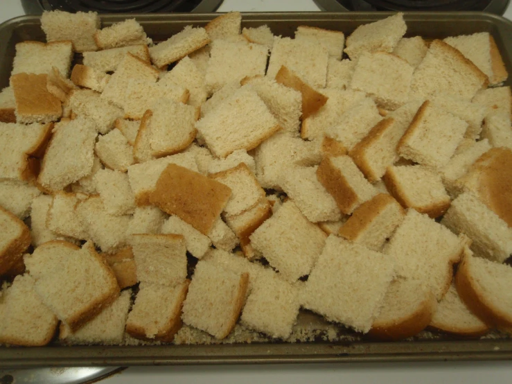 a pan filled with toasted bread on top of a stove