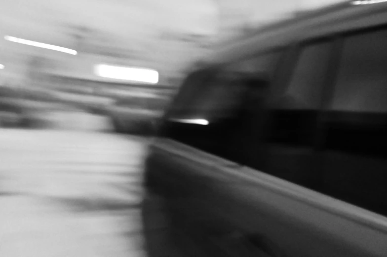 black and white picture of cars in motion