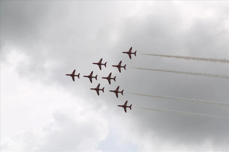 a group of airplanes flying through a cloudy sky