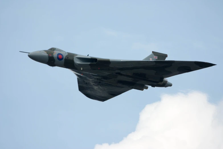 a fighter jet flying through a blue sky