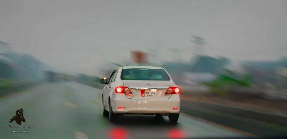 the white car is making it's way down the road