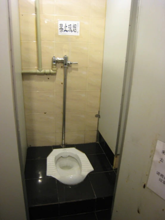 a toilet in a bathroom with a black floor