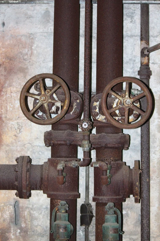 an old, rusty metal object with some gears