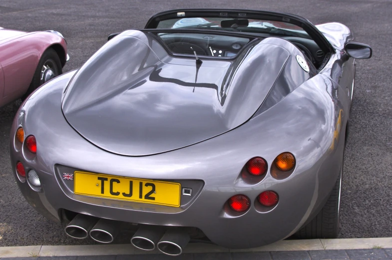 a silver car parked next to two other cars