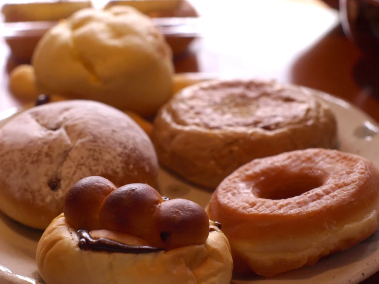 assorted pastries on plates sitting on a wooden table