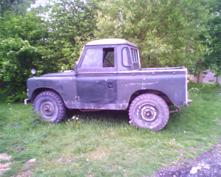 a gray truck is in a grassy area