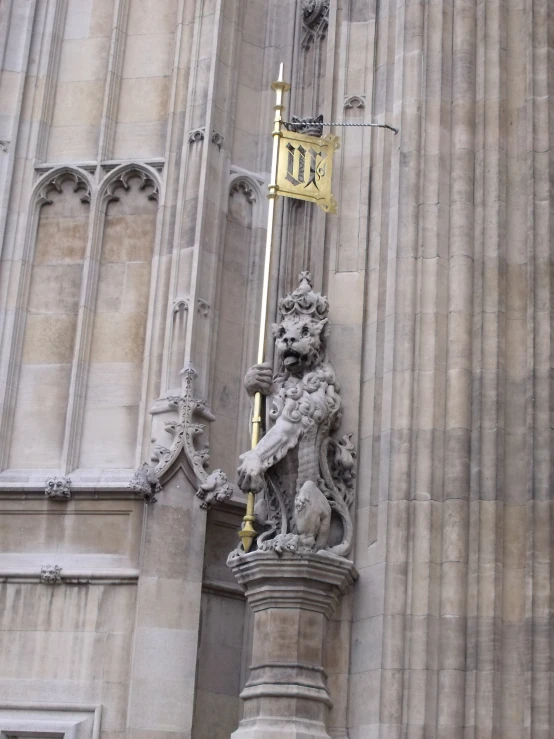 a stone sculpture is standing by the columns