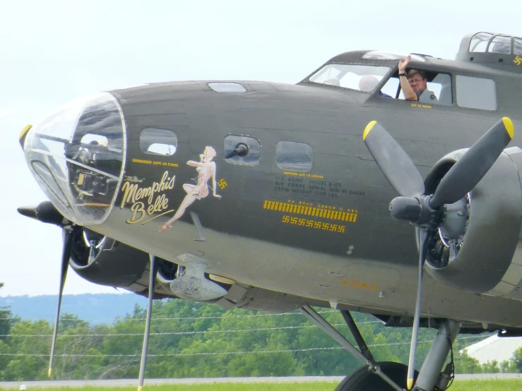 the old, antique airplane has been painted with human drawings