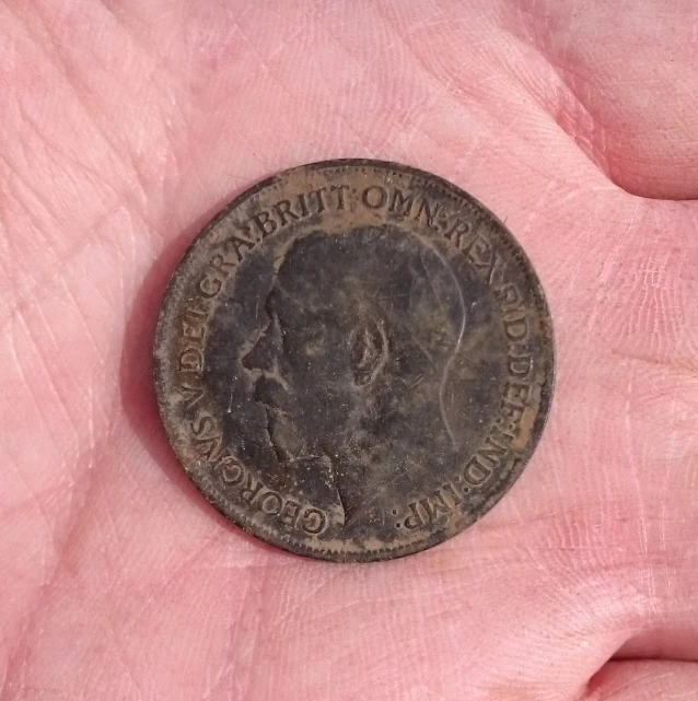 an old coin is shown in someone's palm