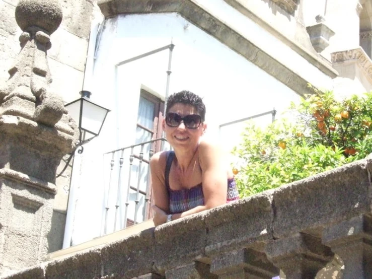 a lady on the top of an outdoor balcony