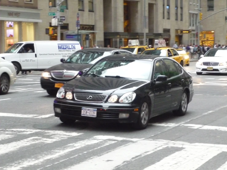 several cars are stopped at a red light on a city street