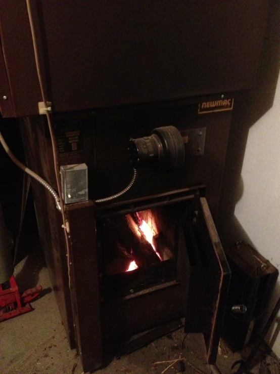 a fire inside of a furnace in a room