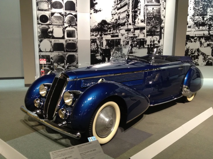 a vintage model car on display with an advertit for bmw