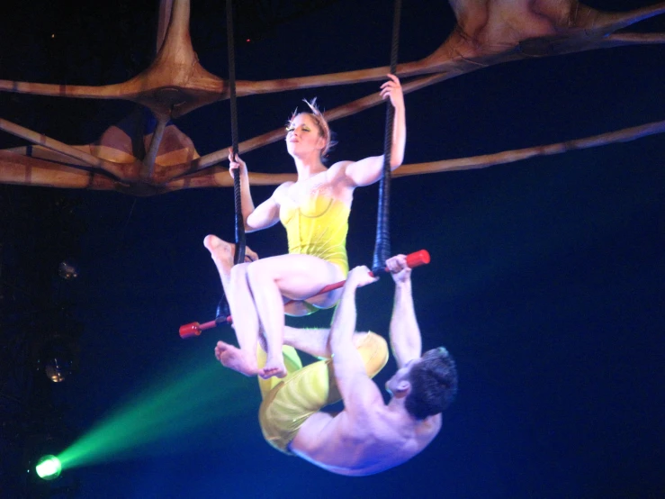 woman and man on aerial aerial acrobatics on a stage