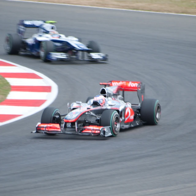 two red and white racing cars in motion