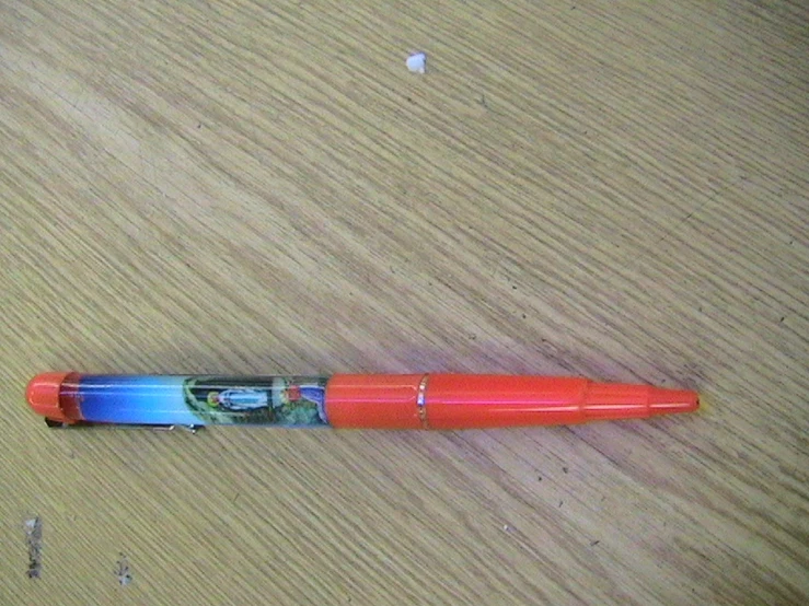 a pen sitting on a table near some writing