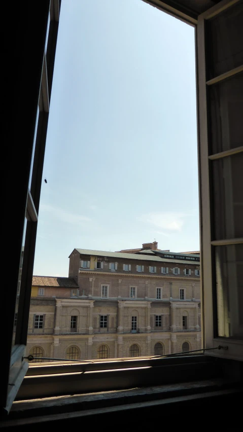 a clock tower is seen from inside the building