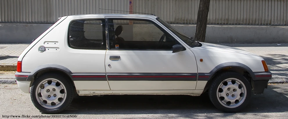 a white car parked next to a building