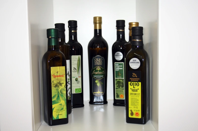 four bottles of olive oil, each with their own label