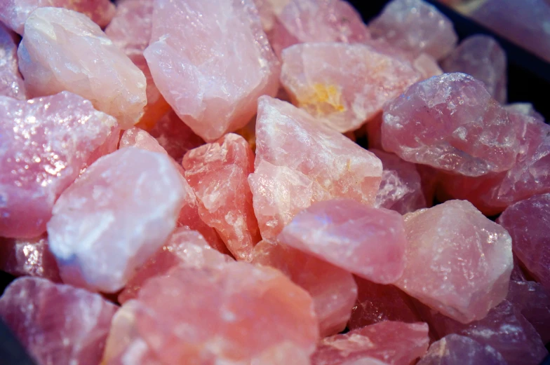several crystals are in a bowl and the pink color is not