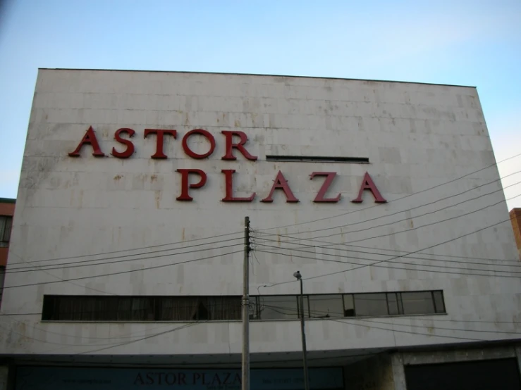 a white building with a large word that reads astou plaza on it