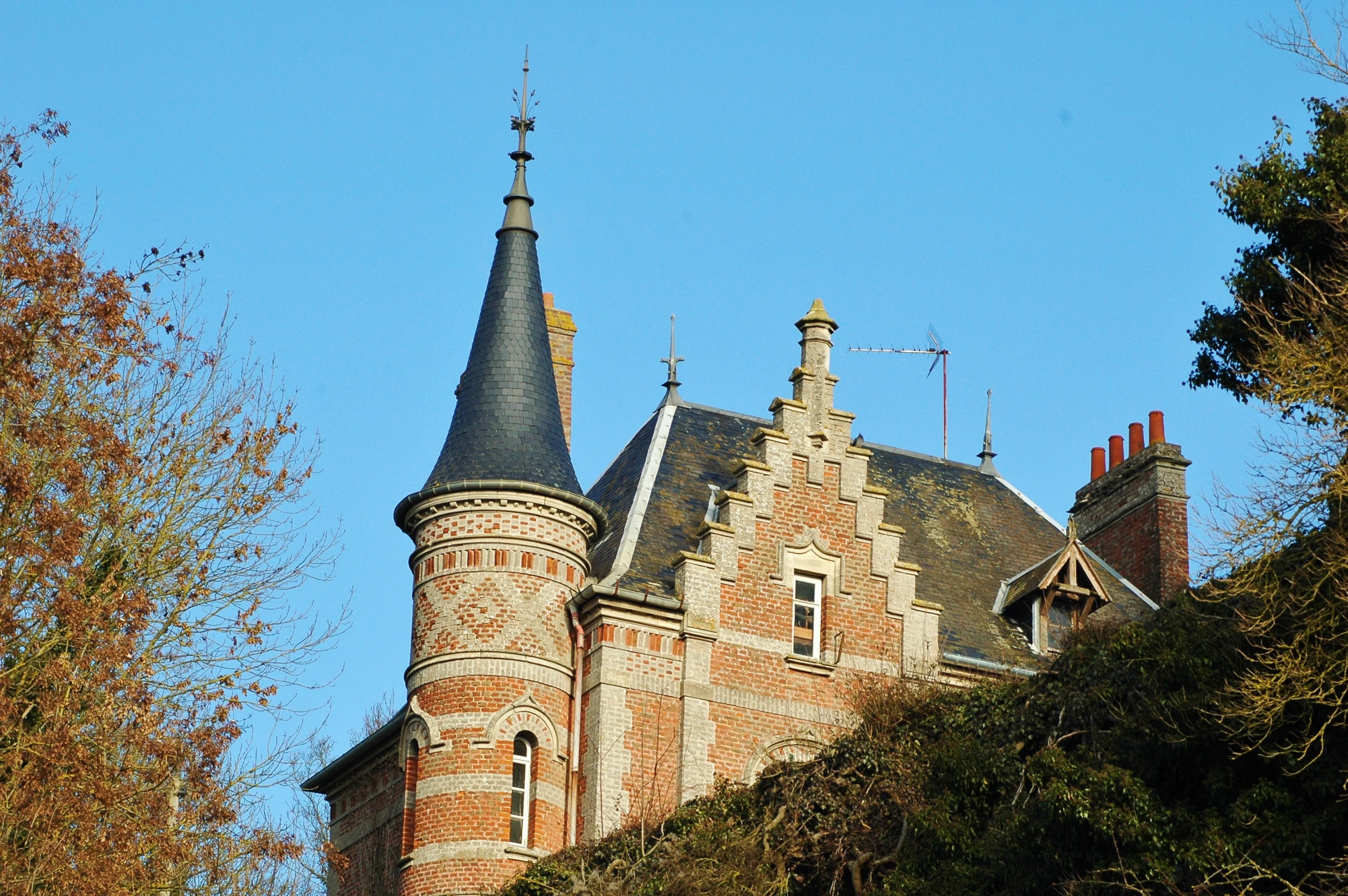 an old castle with steeple and tower in the middle