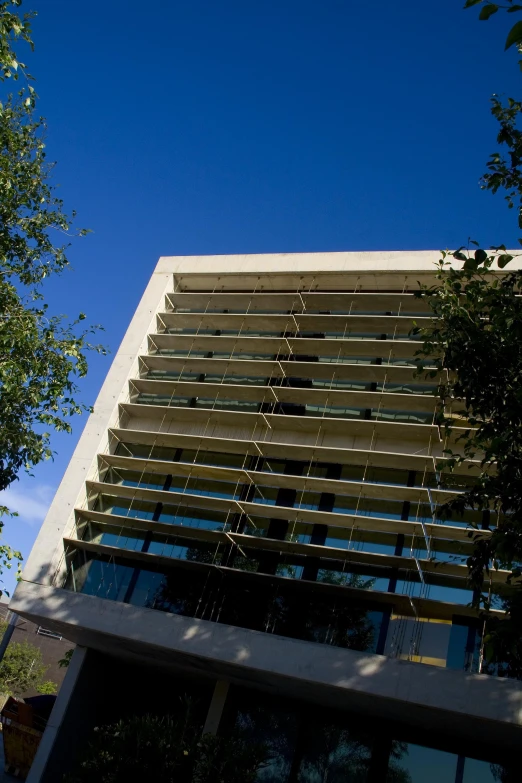 a clock is on the side of a tall building