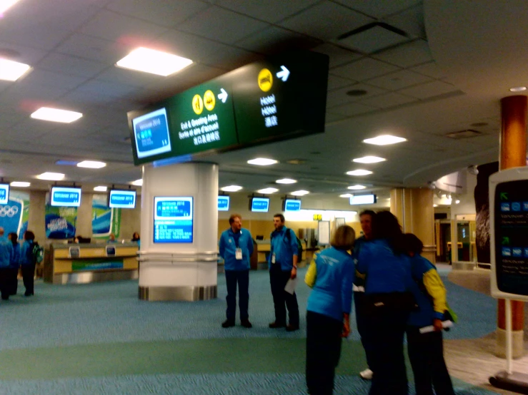 several people standing in a long line at an airport