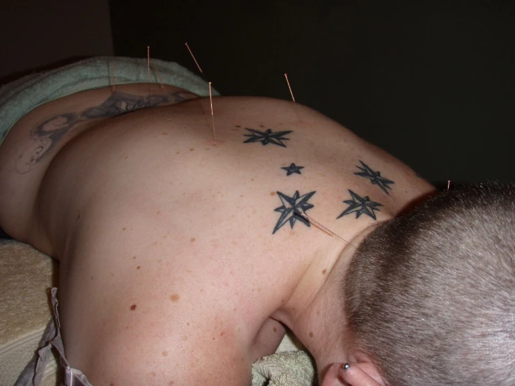 a person has their back turned to the right, with four pointed stars in the middle