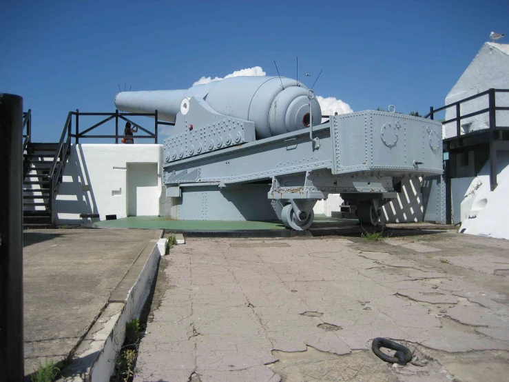 a grey metal object on top of a building