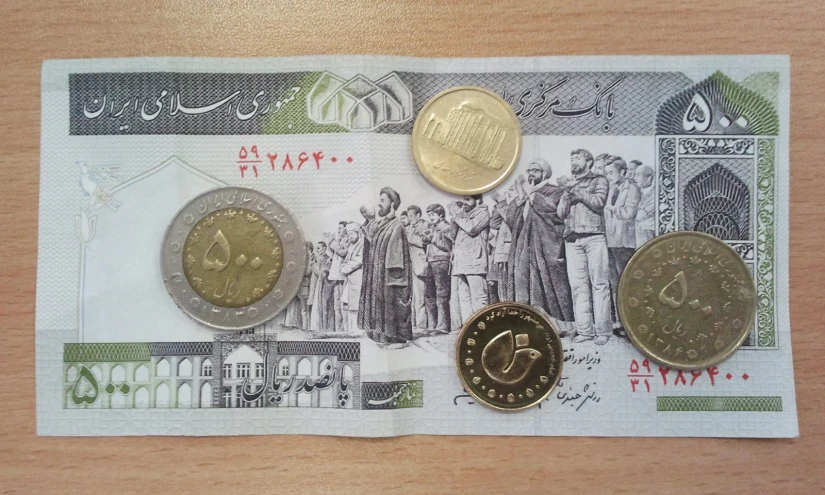 three different sized israeli money bills with gold and silver coins