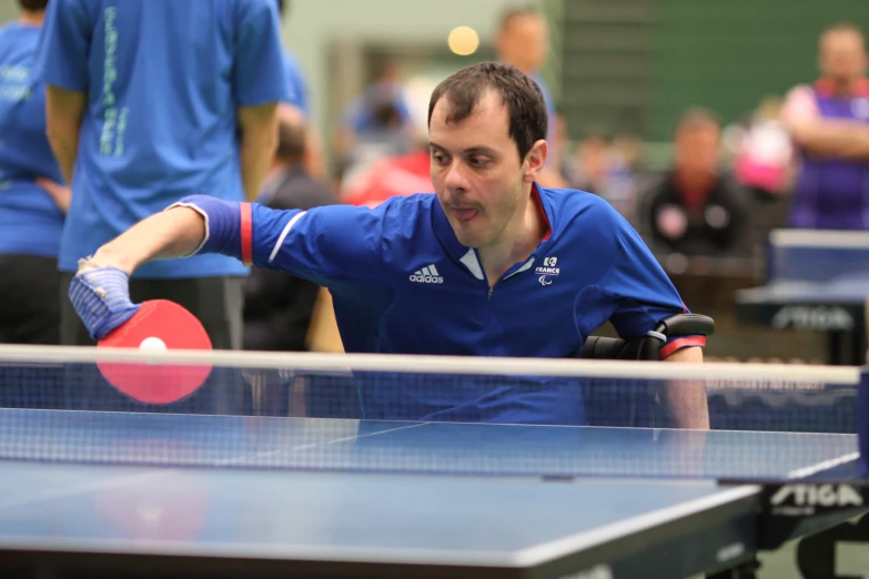an image of a man playing table tennis