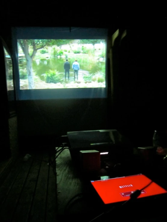the back of a movie screen is shown in a dark room
