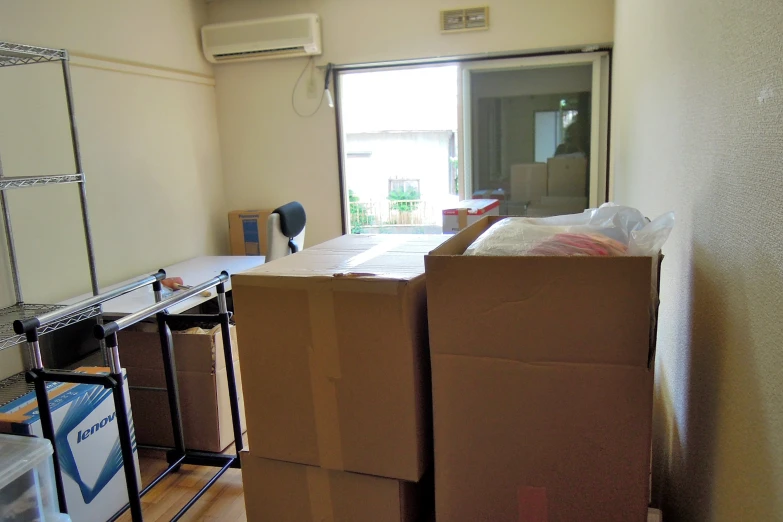 a pile of moving boxes and a box on a work bench