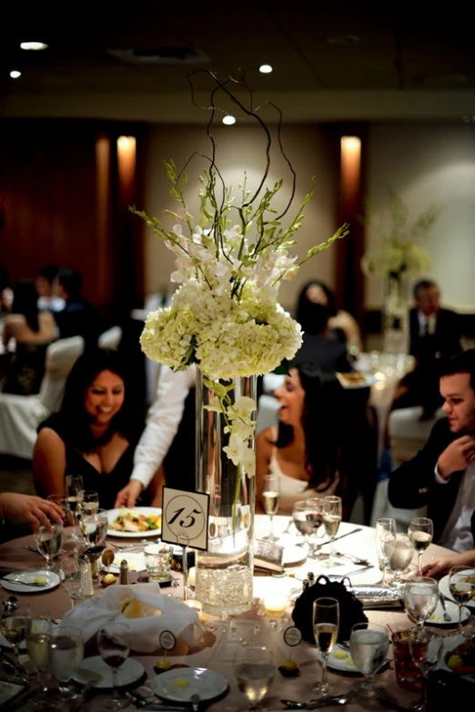 there are people sitting around a table sharing a meal