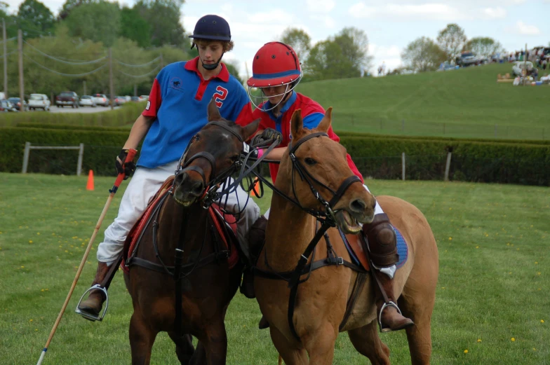 two people riding on the backs of brown horses