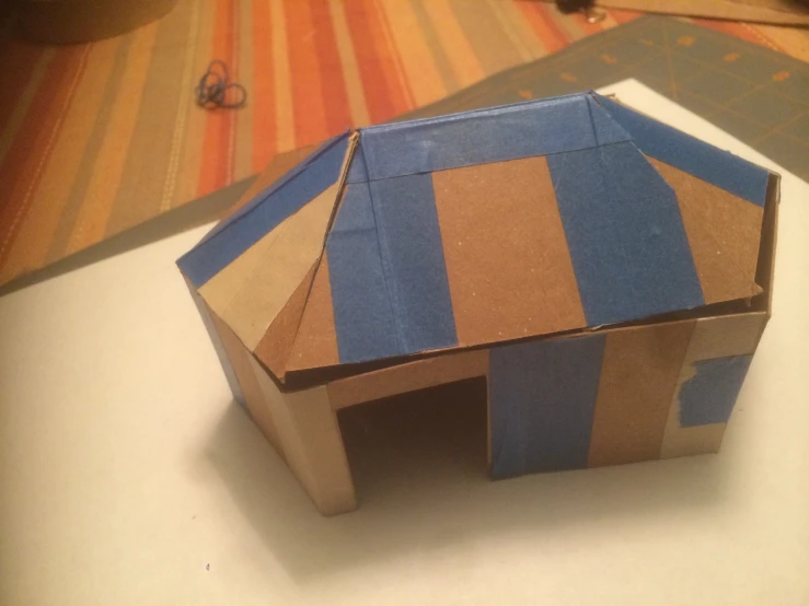 an origami model of a small house sitting on a table