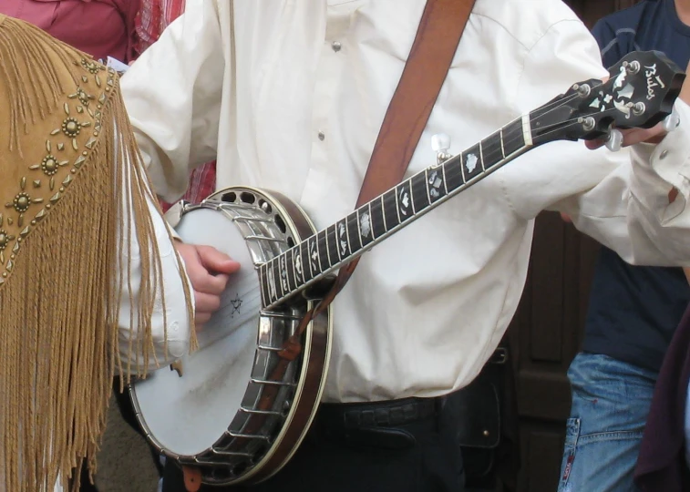 there is a man wearing a tie that has a guitar in his lapel