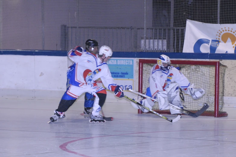 two boys playing with a hockey team in the rain
