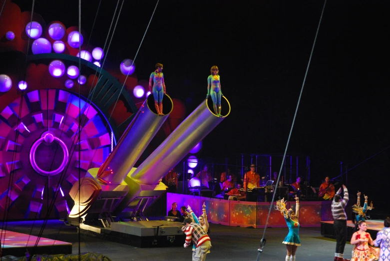 a circus with several performers performing a stunt