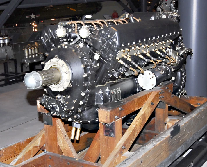 a large wooden crate with an old jet engine in it