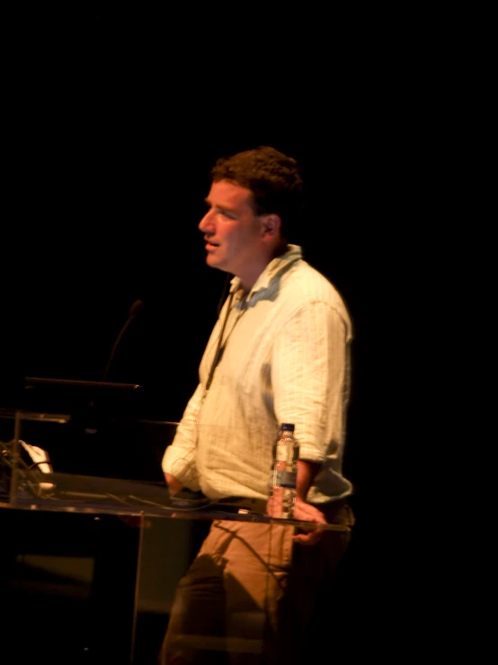 a man in front of a microphone giving a speech