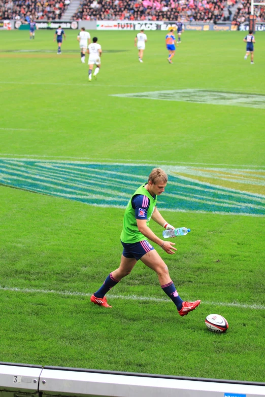 a woman plays soccer on a grassy field