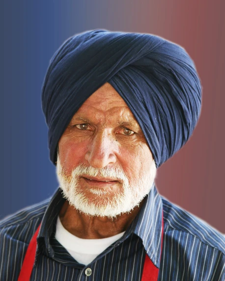 a man wearing a turban with a striped shirt and suspenders