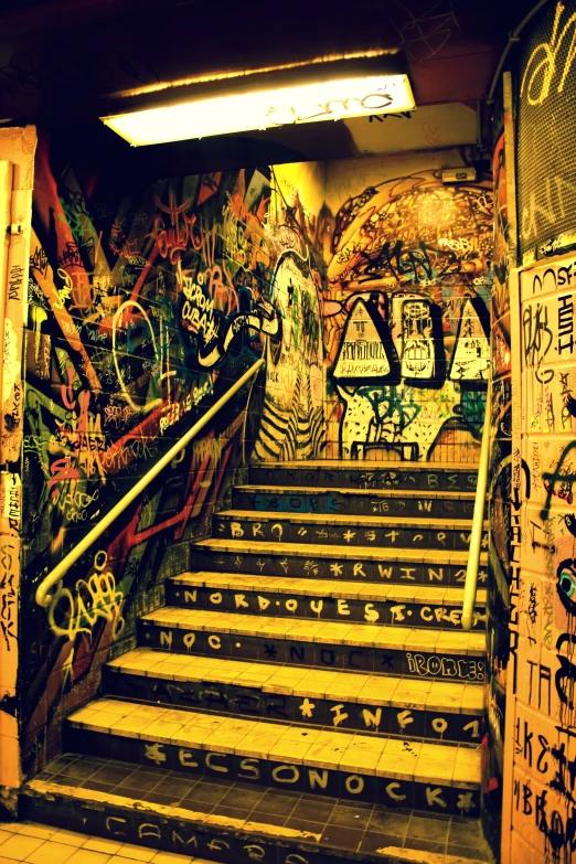 graffiti adorns a wall next to a staircase