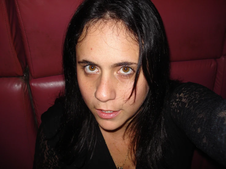 woman with freckles, eyes half - way close, standing on the couch