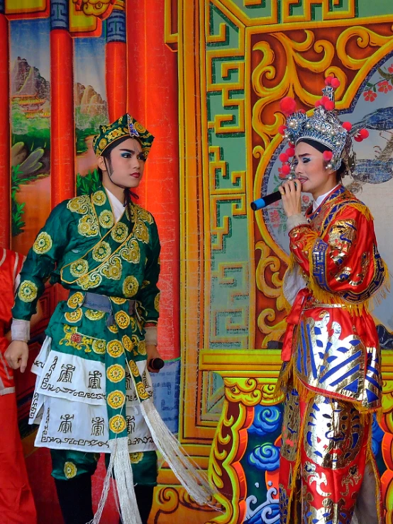 two men wearing asian costume standing next to each other