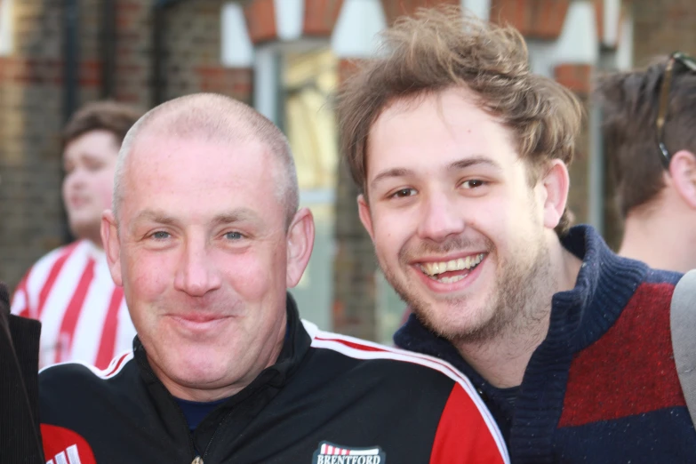 two men posing for the camera next to each other