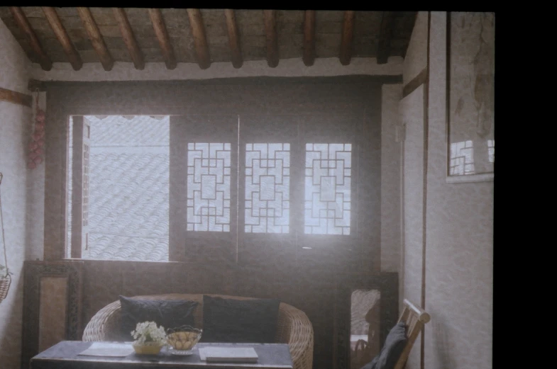 some chairs and tables with flower arrangement near window