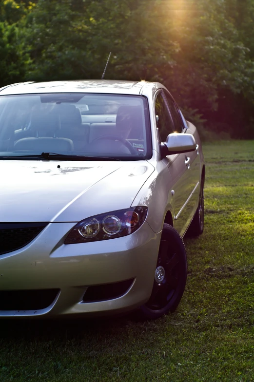 there is a white car parked in the grass